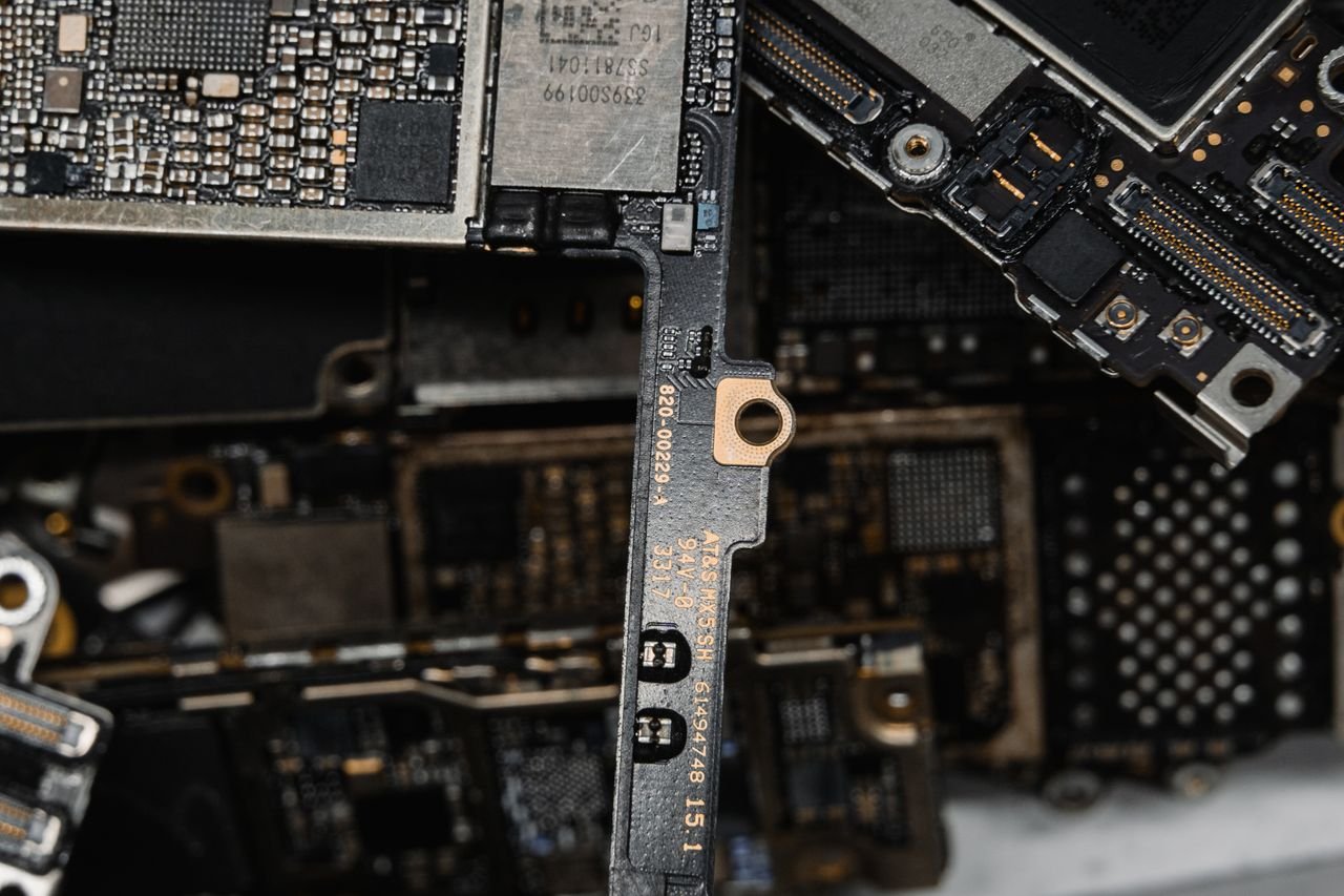 Close-up of a phone logic board during repair